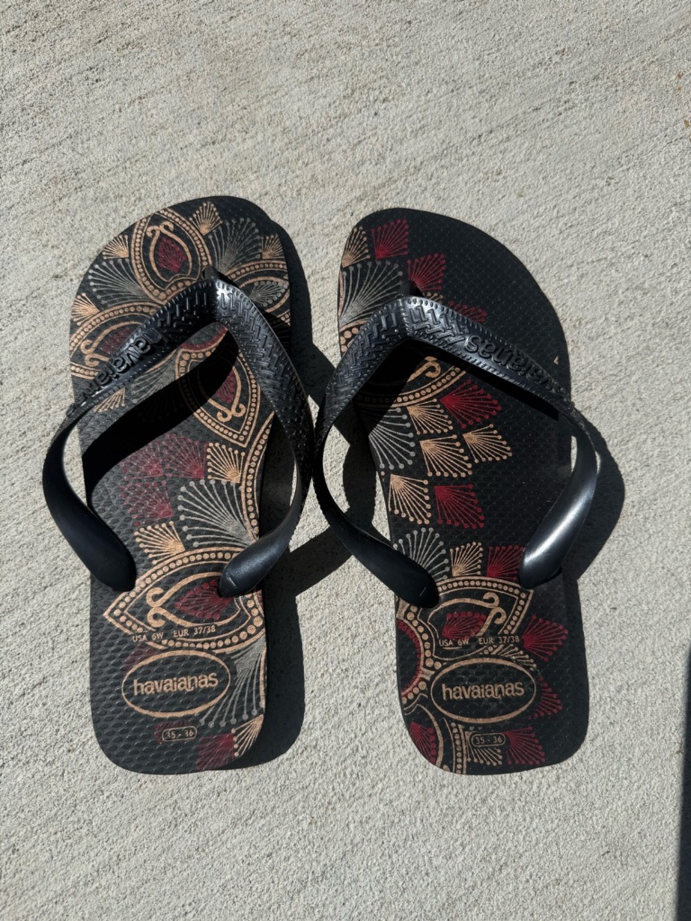 SOLD Havaianas Black Flip Flops with Red and Gold Design